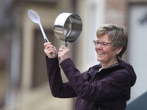 Christy Bedard uses a saucepan and a spoon to make noise near her home.  She, and some of her neighbours,  plans to make noise to thank healthcare workers at 7:30 pm.   Friday, April 10/2020 Winnipeg Sun/Chris Procaylo/stf