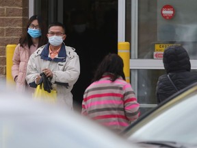 Customers wearing masks leave a grocery shop in Winnipeg. John Graham, the Retail Council of Canada director of government relations for the Prairies, said some bandits are using the fear associated with COVID-19 and social distancing to their advantage. It is also becoming increasingly difficult to identify suspects due to the proliferation of face masks in public.