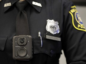 CP-Web.  Montreal this week became the latest city in North America to decide against arming police with cameras. Newark police officer Veronica Rivera displays how a body cam is worn during a news conference unveiling the department's new cameras at the Panasonic headquarters in Newark, N.J., Wednesday, April 26, 2017. THE CANADIAN PRESS/AP-Julio Cortez ORG XMIT: CPT136