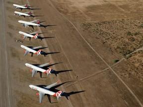 Air Canada Rouge planes, idled by COVID-19 flight restrictions, sit parked at Pinal Airpark near Tuscon, Ariz., on May 16, 2020.