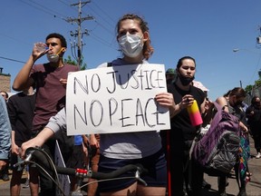 Demonstrators protest the killing of George Floyd outside of the city's 5th police precinct on May 30, 2020 in Minneapolis, Minnesota. Former Minneapolis police officer Derek Chauvin was taken into custody for Floyd's death. Chauvin has been accused of kneeling on Floyd's neck as he pleaded with him about not being able to breathe. Floyd was pronounced dead a short while later. Chauvin and 3 other officers, who were involved in the arrest, were fired from the police department after a video of the arrest was circulated.