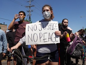 MINNEAPOLIS, MINNESOTA - MAY 30: Demonstrators protest the killing of George Floyd outside of the city's 5th police precinct on May 30, 2020 in Minneapolis, Minnesota. Former Minneapolis police officer Derek Chauvin was taken into custody for Floyd's death. Chauvin has been accused of kneeling on Floyd's neck as he pleaded with him about not being able to breathe. Floyd was pronounced dead a short while later. Chauvin and 3 other officers, who were involved in the arrest, were fired from the police department after a video of the arrest was circulated. (Photo by Scott Olson/Getty Images)