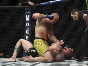 Glover Teixeira pounds Anthony Smith during their UFC fight on Wednesday.