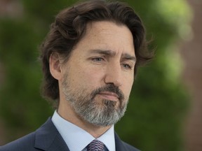 Prime Minister Justin Trudeau is seen as he is asked a question on the military reports on seniors residences during a news conference outside Rideau Cottage in Ottawa, Wednesday May 27, 2020. THE CANADIAN PRESS/Adrian Wyld