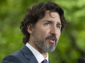 Prime Minister Justin Trudeau responds to a question from a member of the media on site during a daily news conference outside Rideau Cottage in Ottawa, Monday May 25, 2020.