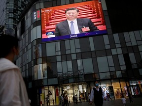 A giant screen on the facade of a shopping mall shows news footage of Chinese President Xi Jinping at the closing session of the National People's Congress (NPC), in Beijing, China May 28, 2020.