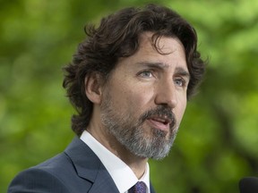 Prime Minister Justin Trudeau responds to a question from a member of the media on site during a daily news conference outside Rideau Cottage in Ottawa, Monday May 25, 2020.