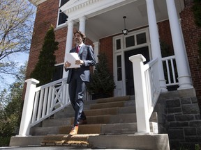 Prime Minister Justin Trudeau walks to the podium for a daily briefing outside Rideau Cottage in Ottawa, Thursday, May 14, 2020.