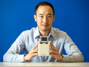 Spartan Bioscience Inc. CEO Paul Lem holds one of his company's COVID-19 portable, rapid testing devices in a handout photo.