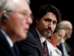 Canada's Prime Minister Justin Trudeau listens to Minister of Public Safety and Emergency Preparedness Bill Blair during a news conference on Parliament Hill in Ottawa, Ontario, Canada May 1, 2020. REUTERS/Blair Gable