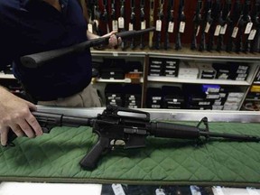 In this file photo, an AR-15 rifle is displayed at a gun shop in Auroro, Colo., on July 22, 2012.