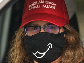 A demonstrator wearing a face mask looks on during a MAGA May Day rally in Stream Valley, New York, on May 1, 2020.