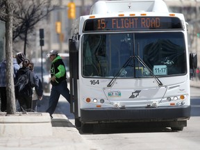 A Winnipeg Transit bus stops to let a passenger off. The Standing Policy Committee on Infrastructure Renewal and Public Works passed a motion on Tuesday to procure 32 diesel low-floor buses.