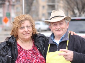 Hot dog vendors Roza Kokin, 68 and her husband Leonid, 64, react in Osborne Village in Winnipeg on Friday to the Manitoba government's plans to reopen some non-essential businesses.