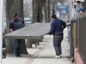 Preparations underway Saturday on Corydon Avenue to open up patios.