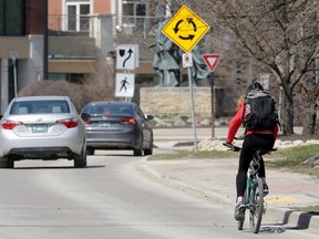 A cyclist approaches a traffic calming circle on Waterfront Drive at Bannatyne Avenue in Winnipeg on Wed., May 6, 2020. Kevin King/Winnipeg Sun/Postmedia Network