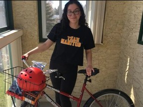 Program participant 17-year-old Amayra Wilson with her bike, helmet, lock, light and a tire pump. The Manitoba Aboriginal Sports and Recreation Council are working with Winnipeg Repair Education and Cycling Hub (WRENCH) to provide bikes to Indigenous students with their program called Cycle Indigena Winnipeg.