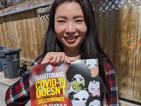 Jennifer Chen, a community activist and Winnipeg School Division Trustee, holds a poster from the Immigration Partnership Winnipeg (IPW) — together with several partnering organizations — public awareness-building campaign, entitled: “Manitobans: COVID-19 Doesn’t Discriminate. Nor Should You!” in response to increasing COVID-19-related acts of racism, discrimination and xenophobia in Manitoba.