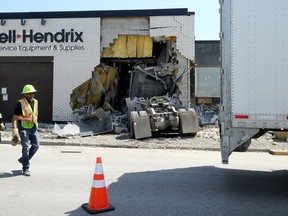 A semi-trailer is taken away after being removed from the tractor unit which crashed into Russell Hendrix Restaurant Equipment & Supplies on Erin Street at Ellice Avenue in Winnipeg on Wed., May 20, 2020. Kevin King/Winnipeg Sun/Postmedia Network