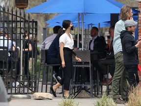 An Earls Main Street hostess works its busy patio in Winnipeg on Thurs., May 21, 2020. Restaurants will be able to resume dine-in services at 50% capacity during the second phase of the province's reopening plan.