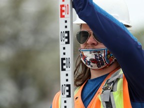 A city employee sporting a Captain America mask works at a road construction project on Tache Avenue at Marion Street in Winnipeg on Thurs., May 21, 2020. Kevin King/Winnipeg Sun/Postmedia Network