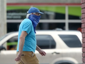 A man walks along Osborne Street while wearing a mask on Saturday.
