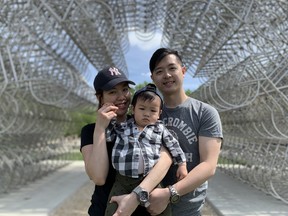 The Tsang family enjoys a walk along the Winnipeg Loop next to the Bicycles are Forever sculpture in Winnipeg on Monday.
