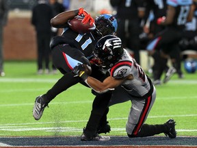 Joshua Crockett of the Dallas Renegades is tackled by Ranthony Texada (right) of the New York Guardians during an XFL game on March 07. Texada was one of two importants the Winnipeg Blue Bombers added on Monday.