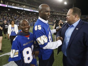 Former Winnipeg Blue Bomber Milt Stegall, along with his son Chase, is at his Ring of Fame ceremony in 2016.