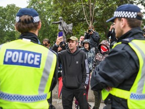 Police officers are seen next to right wing protesters in Parliament Square on June 12, 2020 in London, United Kingdom.