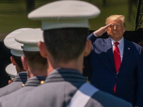 U.S. President Donald Trump salutes cadets at the beginning of the commencement ceremony on June 13, 2020 in West Point, N.Y.