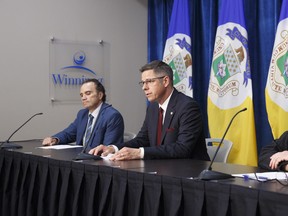 (Left to right) Chief Danny Smyth, Winnipeg Police Service, Mayor Brian Bowman, Chief John Lane, Winnipeg Fire and Paramedic Service provide their reaction to the events in Minneapolis, across the US and in Canada during a media conference at City Hall on Tuesday.
