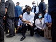 Prime Minister Justin Trudeau wears a mask as he takes a knee during a rally against the death in Minneapolis police custody of George Floyd, on Parliament Hill, in Ottawa, June 5, 2020.