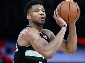 In this file photo Milwaukee Bucks forward Giannis Antetokounmpo controls the ball during the NBA basketball match between Milwaukee Bucks and Charlotte Hornets at The AccorHotels Arena in Paris on Jan. 24, 2020.