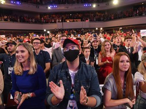 In this file photo taken on June 23, 2020 Supporters listen as U.S. President Donald Trump speaks during a Students for Trump event at the Dream City Church in Phoenix, Ariz.