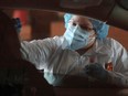 Claudia Clemente, MA, performs a test for COVID-19 as part of Valle del Sol’s testing at Tolleson Fire Department Station 161 in Tolleson, Ariz., Thursday, June 18, 2020.