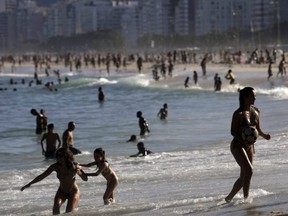 Beachgoers enjoy Leme beach amid the COVID-19 outbreak in Rio de Janeiro, Brazil, Sunday, June 21, 2020.