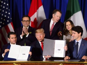 Prime Minister Justin Trudeau, right to left, Foreign Affairs Minister Chrystia Freeland, United States Trade Representative Robert Lighthizer, President of the United States Donald Trump, Mexico's Secretary of Economy Ildefonso Guajardo Villarreal, and President of Mexico Enrique Pena Nieto participate in a signing ceremony for the new United States-Mexico-Canada Agreement in Buenos Aires, Argentina, Friday, Nov. 30, 2018.