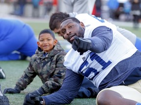 Blue Bombers offensive lineman, Jermarcus Hardrick has some fun with his son, Jermarcus Hardrick Jr., during practice at McMahon Stadium ahead of the 107th Grey Cup in Calgary.