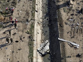 In this Wednesday, Jan. 8, 2020 photo, rescue workers search the scene where a Ukrainian plane crashed in Shahedshahr, southwest of the capital Tehran, Iran.