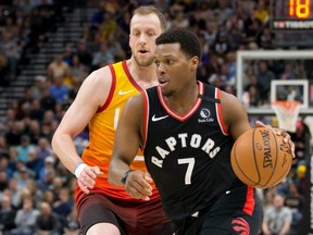 Raptors guard Kyle Lowry dribbles the ball ahead of Jazz guard Joe Ingles during first half NBA action at Vivint Smart Home Arena in Salt Lake City, March 9, 2020.