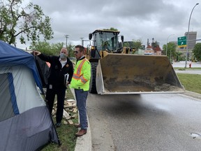 Mark Reshaur, assistant chief, fire and EMS prevention and public education was tasked with the difficult job of serving eviction orders on Wednesday morning at the homeless encampment next to the Manitoba Metis Federation.
James Snell/Winnipeg Sun