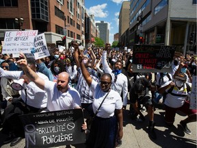 People take a knee during a protest against racial inequality and police brutality in the aftermath of the death in Minneapolis police custody of George Floyd, in Montreal, Quebec, Canada June 7, 2020. REUTERS/Christinne Muschi