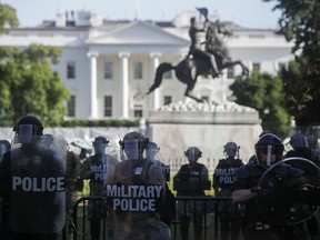 D.C. National Guard military police officers look on as demonstrators rally near the White House against the death in Minneapolis police custody of George Floyd, in Washington, D.C., June 1, 2020.