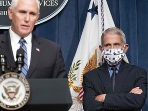 In this file photo taken on June 25, 2020 Anthony Fauci watches as Vice President Mike Pence speaks after leading a White House Coronavirus Task Force briefing at the Department of Health and Human Services in Washington.