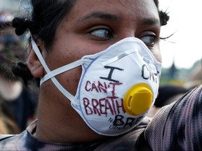 A protester wearing a mask attends a rally against the death in Minneapolis police custody of George Floyd, on Parliament Hill, in Ottawa, June 5, 2020.