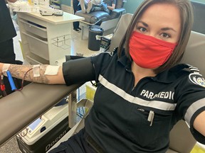 Regular blood donor and paramedic Rebecca Clifton donates blood at Canadian Blood Services donor centre at 777 William Ave., in Winnipeg in May, 2020. Clifton, who is also the administrative director of the Paramedic Association of Manitoba, organized the blood drive by 38 paramedics to help mark Paramedic Services Week by giving the gift of life.