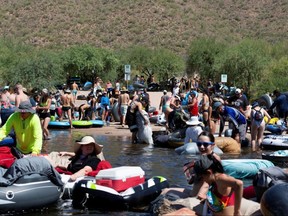 People prepare to go tubing on Salt River amid the outbreak of COVID-19 in Arizona, Saturday, June 27, 2020.