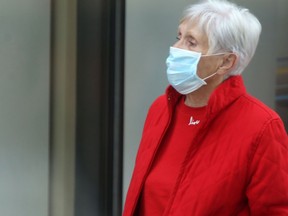 A woman wearing a mask walks along Portage Avenue, in downtown Winnipeg.  Tuesday, June 9/2020.