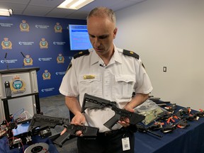 Winnipeg Police Insp. Max Waddell shows off a prohibited AR-15 rifle lower end receiver manufactured from a 3-D printer (left) and an authentic AR-15 lower end receiver at a press conference at Winnipeg Police headquarters on Tuesday, June 9. 2020. Winnipeg Police announced a large seizure of firearms in two separate investigations including the AR-15 lower end receiver and a Glock 19 handgun lower receiver which had been manufactured out of plastic using a 3-D printer. The manufactured firearms are referred to as 'ghost guns' as they have no serial number.